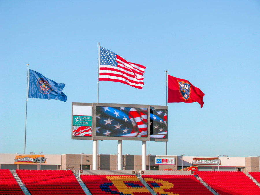 Giant Steel Flagpoles at a jumbo stadium manufactured with the highest quality materials from Colonial Flag
